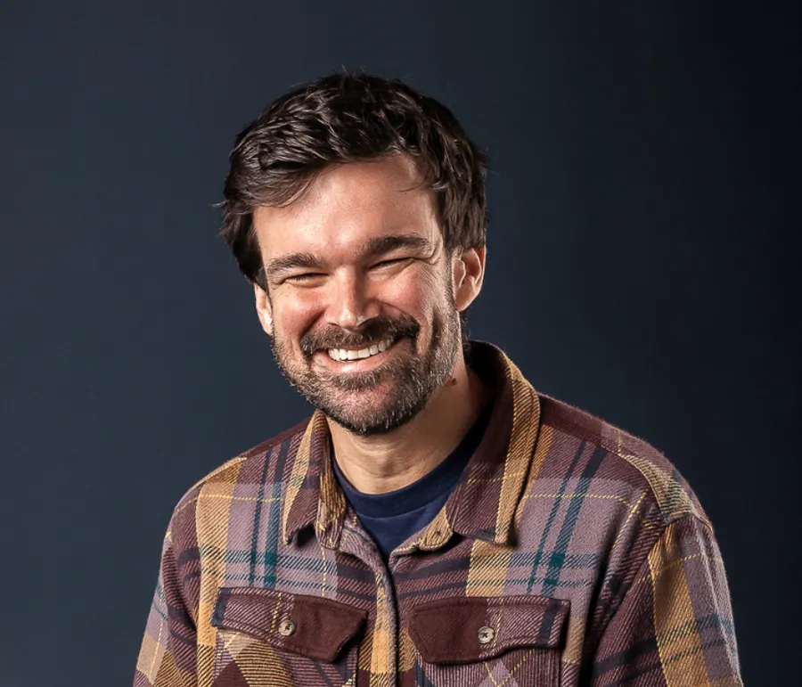 Matt from MattSimplified smiling in a plaid shirt